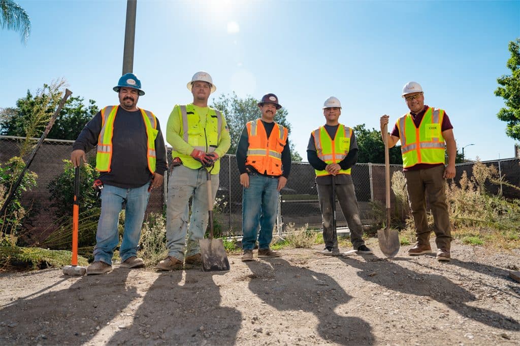 Cook Builders industrial contractors wearing high-visibility vests and hard hats at an industrial construction site in Utah